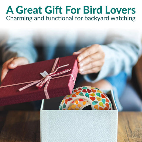 Person opening gift box containing 6 Inch Glass Mosaic Hanging Bird Feeder For Outdoors with colorful confetti mosaic design.