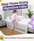 Keep Lil Ones Snuggled With This Smooth Swing Down Toddler Bed Rail. Toddler climbing onto a bed with gray safety rail in a bedroom.