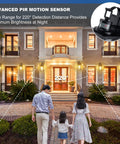 Smart Motion Sensor Outdoor Wall Lantern Dusk To Dawn Sconce in matte black installed on a porch with nighttime illumination.