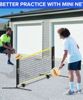 Two people playing with a Six Foot Mini Pickleball Net Set With Quick Setup For Indoor And Outdoor Play Portable Practice Net