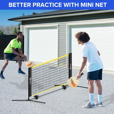 Two people playing with a Six Foot Mini Pickleball Net Set With Quick Setup For Indoor And Outdoor Play Portable Practice Net