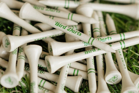Premium Bamboo Golf Tees In Cigarette Style Pack Two And Three Quarter Inch Tees Durable Biodegradable Wood 18 Pack shown on grass