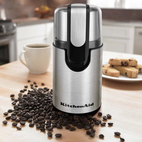 Blade Coffee Grinder With One Touch Control, 4 Ounce Capacity, Onyx Black, on kitchen counter next to coffee beans and cup