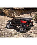 SCX24 Jeep Gladiator One Twenty Fourth Scale 4x4 Rock Crawler Ready To Run Brushed RC Car on rocky terrain
