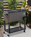 80 Quart Rolling Patio Cooler With Bottle Opener And Cap Catcher in gray on wheels, beside outdoor grill
