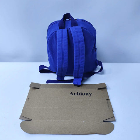 Rear view of Lightweight Daypack For Hiking And Camping In Bold Blue 11 By 9 By 10 Inches Trail Ready And Super Durable Backpack with box