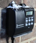 Outdoor Timer With 7 Day Programming And Astronomic Self Adjust mounted on brick wall with snow, weatherproof enclosure