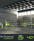 Various Greenworks yard tools displayed against a wall, including mowers, blowers, and trimmers under overhead lighting.
