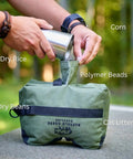 Person filling All Weather Front And Rear Shooting Bag Combo For Target Practice And Bench Rest Use with filler options shown