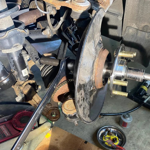 Wheel Bearing Removal And Installation Tool Kit For Front Rear And All Wheel Drive Vehicles with hub puller in use on suspension