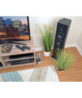 Living room setup with Isobar 8 Outlet Surge Protector Power Strip With 25 Foot Cord, Right Angle Plug, by TV stand and speakers.