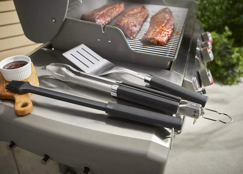 Precision 3 Piece Grilling Tool Set With Stainless Steel Tongs Spatula And Silicone Basting Brush on outdoor grill next to ribs.