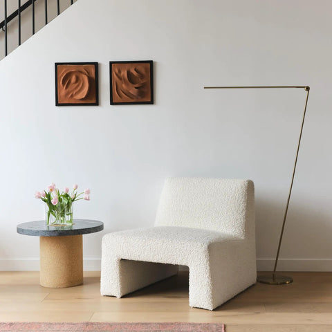 Libra LED Floor Lamp With Adjustable Pivot Arm And Built In Dimmer next to modern chair and table in living room.