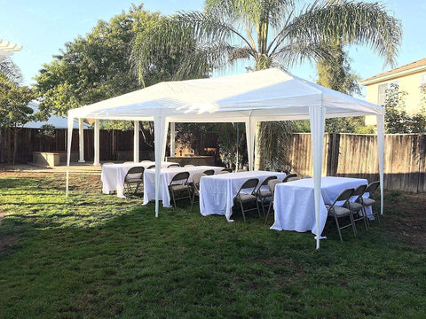 10x20 Outdoor Party Tent Gazebo With Removable Church Sidewalls For Weddings And BBQs set up in a backyard with tables and chairs.