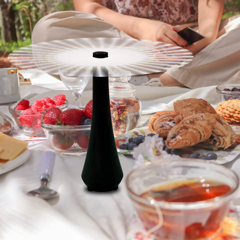 Close-up of Three Pack Battery Operated Tabletop Fly Fans for indoor or outdoor use with food at a picnic.