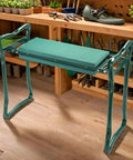 Garden Kneeler And Seat Flip Bench For Comfortable Outdoor Gardening With Thick Foam Cushion Sturdy Lightweight Frame Handy Handles To Stand Up Easy Converts From Kneeler To Seat In Seconds For Cushioned Kneeling Or Sitting shown in a garden setting.