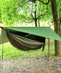 Double Parachute Nylon Camping Hammock Set With Rain Fly Tarp Mosquito Net And Tree Straps in a forest setting.