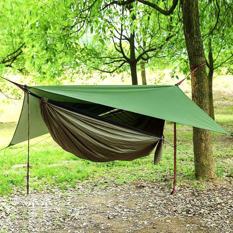 Double Parachute Nylon Camping Hammock Set With Rain Fly Tarp Mosquito Net And Tree Straps in a forest setting.