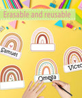 Rainbow Cutouts For Classroom Decor, 45 Pcs Boho Rainbow Name Tags With 100 Glue Dots on yellow desk with hands writing names