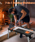 Heavy Duty Adjustable Work Bench And Rolling Tool Storage Cart With Four Locking Caster Wheels Transforms Into Sawhorse Scaffold And Hand Truck For Badass Shop Rigs, being used for drilling on wooden boards.