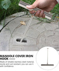 Heavy Duty Steel Manhole Cover Lifter Hook And Forty Three Inch Roller Shutter Prying Bar With Rock Solid Eight Millimeter Framework For Drainage Grates And Utility Doors Built Like A Tank, stainless steel hook in use.