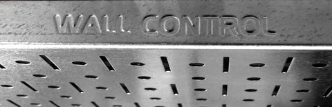 Close-up of metal pegboard with 'Wall Control' lettering, part of Power Tool Storage Organizer Kit With Cordless Drill Holder And Charging Station.