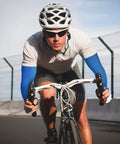 Cyclist wearing blue Unisex UV Protection Arm Sleeves Set 12 Pairs Long Cooling Cover For Outdoor Adventures
