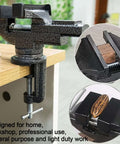 Universal 3-inch table vise, clamp-on bench vise in black with 360° swivel base mounted to wooden workbench.