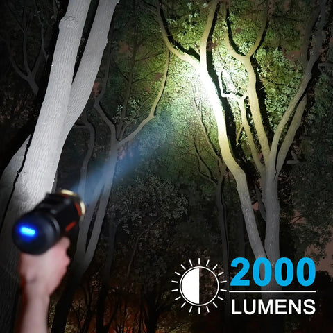 Person using 2000 Lumen Marine Spotlight Waterproof Rechargeable Handheld Flashlight For Boats With IP67 Rating, illuminating trees at night.