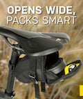 Aero Wedge Pack Small Strap Mount Seat Bag for Tubes and Tools built for cyclists, open under bike saddle, showing interior storage.