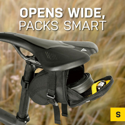 Aero Wedge Pack Small Strap Mount Seat Bag for Tubes and Tools built for cyclists, open under bike saddle, showing interior storage.