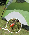 11 Inch Tent Stakes 10 Pack Heavy Duty Ground Anchors for Outdoor Camping and Gazebo Setup securing a green tent