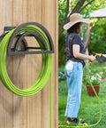 Heavy Duty Outdoor Hose Holder Wall Mount for 125Ft Hose, Detachable Reel Storage Organizer on wooden wall, green hose