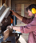 Man using saw with Hardcore Metal Mesh Cut Resistant Glove For Meat Cutting Butcher Grade Food Safe Chainmail Hand Protection