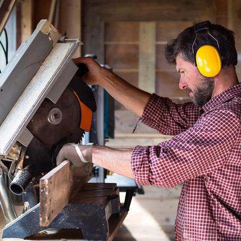 Man using saw with Hardcore Metal Mesh Cut Resistant Glove For Meat Cutting Butcher Grade Food Safe Chainmail Hand Protection