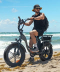 Person riding ebike with Heavy Duty Fat Bike Tire 20x4.0 For EBikes And MTB All Terrain Fat Tire on sandy beach