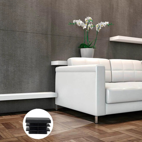 30 Pack One And One Half Inch Square Plastic End Caps installed on chair legs, black, displayed in a modern living room setting.