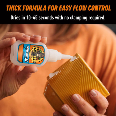 Person using All Purpose Super Glue XL Clear Glue 25g Pack Of 2 For Fast Setting And Strong Bonds On a ceramic item.