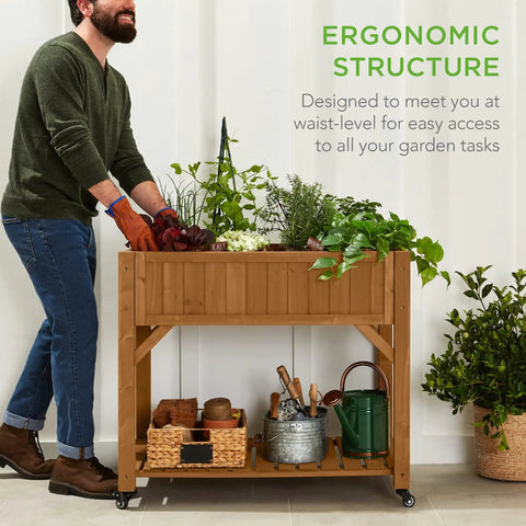 Person using Elevated Eight Pocket Garden Bed With Locking Wheels Mobile Raised Planter For Herbs Vegetables And Flowers Customizable Compartments Built In Storage Shelf And Drainage Holes Acorn Brown