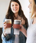 Level Up Your Chill Game With These Freezable Pint Glasses Double Walled Insulated Tumblers That Keep Beer And Iced Coffee Straight Frosty Built To Last Set Of Two Wooden Handles, two women holding cold drinks.