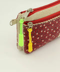 Backpack And Luggage Zipper Pull Replacement Set 10 Pcs Durable Nylon Zipper Tabs With Non Slip Rubber Grip on a red pouch