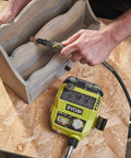 Man using Badass 18 Volt Cordless Mini Rotary Tool With 35 Premium Accessories on carved wooden object.