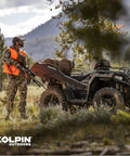 Hunter with Stronghold Gun Boot L with Autolatch Mount Black Hard Case on ATV in wilderness