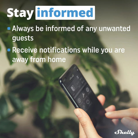 Hand holding phone showing smart home app; "Stay informed" message with notification alerts, green plant in background.