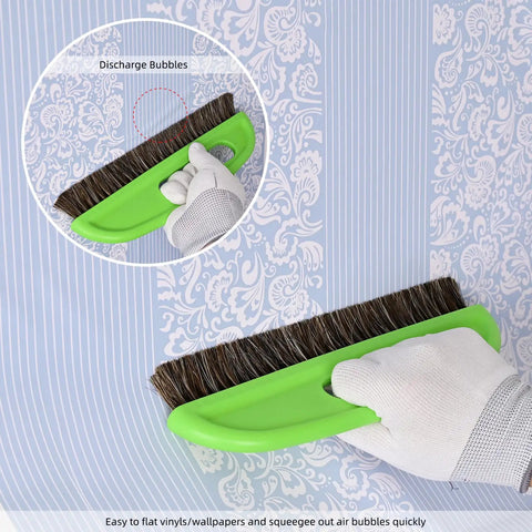 Hand using Wallpaper Smoothing Tool Kit With 10 Inch Smoothing Brush on patterned wallpaper close-up.