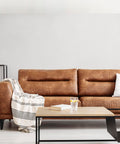 Nash 3 Bulb Semi Flush Light With Seeded Glass In Oil Rubbed Bronze Finish illuminating a modern living room with leather sofa.
