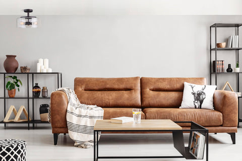 Nash 3 Bulb Semi Flush Light With Seeded Glass In Oil Rubbed Bronze Finish illuminating a modern living room with leather sofa.