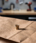 Premium 48Pcs Brass M4 Heat Set Threaded Inserts For 3D Printing With Knurled Design on brown paper background.
