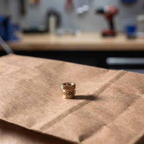 Premium 48Pcs Brass M4 Heat Set Threaded Inserts For 3D Printing With Knurled Design on brown paper background.