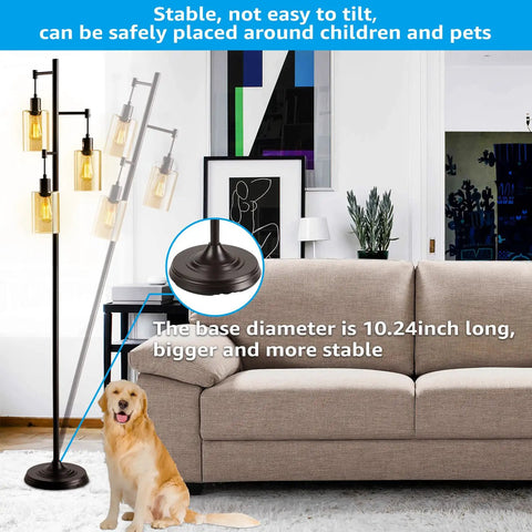Three-Head Industrial Farmhouse Floor Lamp With Amber Glass Shades beside a sofa, showing stable base detail and living room setting.